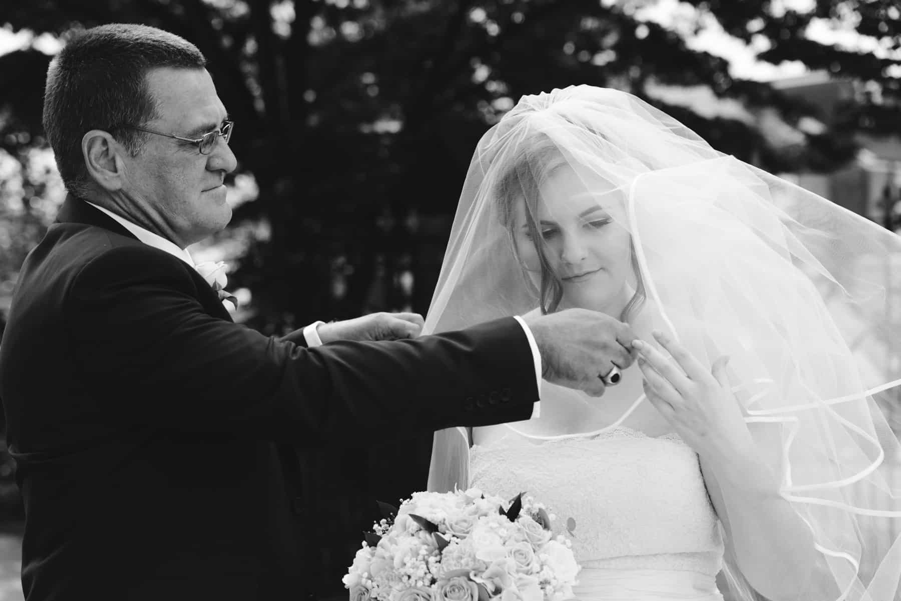 bride's dad lowers her veil